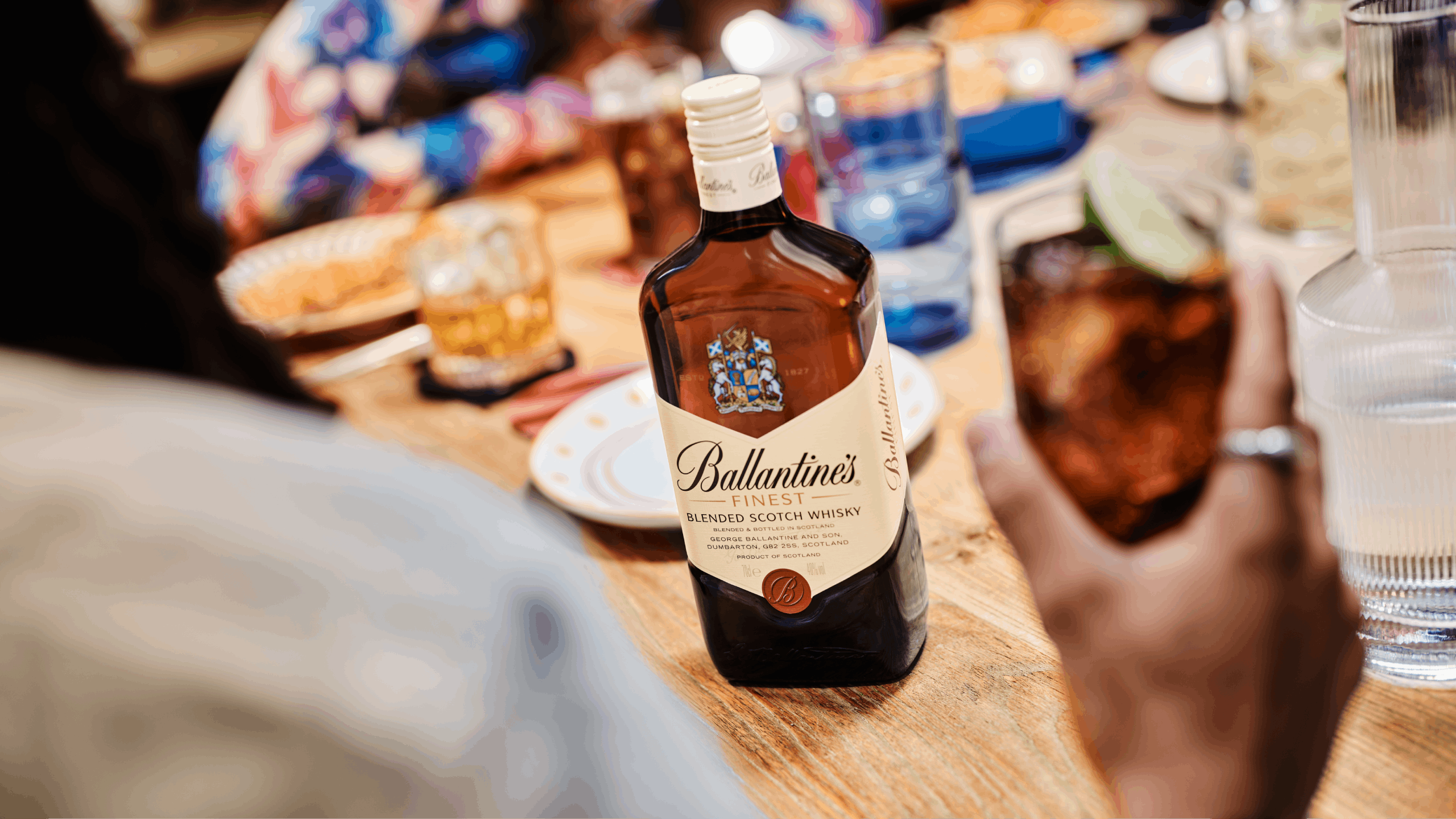 Ballantine's Finest Blended Scotch Whisky being shared at a party